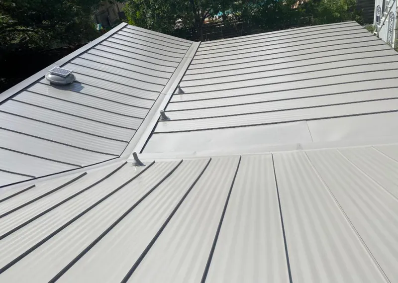 Solar attic fan installed on a metal roof for Roof Ventilation in Seaside